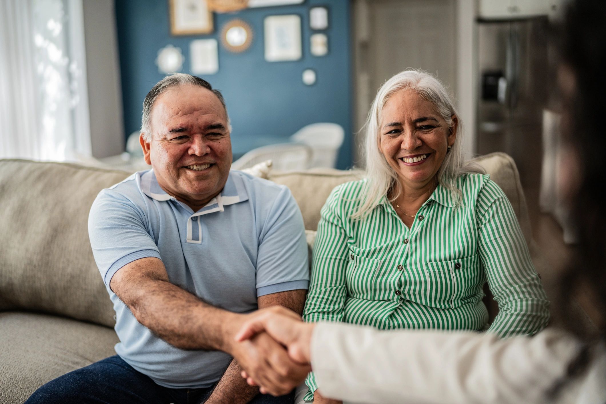 Advisor greeting clients during a personal insurance planning conversation